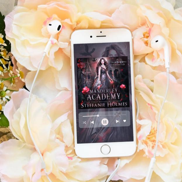 Ghosted audiobook on iphone with flowers in background